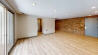 This 910 square foot single-floor residence in Bloomfield, CT, offers a well-designed layout with 2 bedrooms, 2 bathrooms, and 2 kitchens. The home's efficient use of space is evident in its thoughtful room arrangement, including a generous 190 square foot primary bedroom.

Throughout the property, light wood flooring creates a bright, contemporary atmosphere, complemented by recessed lighting and large windows that flood the spaces with natural light. The living area features a striking exposed brick wall, adding character and texture to the modern aesthetic.

Both kitchens showcase sleek designs with dark wood cabinetry, granite countertops, and stainless steel appliances. A dedicated laundry area with ample storage enhances the home's functionality. The bathrooms are elegantly appointed with marble-look tiles, modern fixtures, and a combination of tub and shower options.

The bedrooms offer spacious layouts with large windows and ample closet space. The overall design prioritizes openness and flow, creating a comfortable and inviting living environment. This property at 4 Wedgewood Dr combines modern amenities with practical design, making it an attractive option for those seeking a contemporary home in a convenient location.