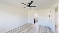 This efficiently designed 590 square foot apartment in Alhambra, CA offers a surprising amount of space with three bedrooms and one bathroom. The primary bedroom is generously sized at 170 square feet, providing ample room for a comfortable retreat. Throughout the apartment, modern finishes create a fresh and inviting atmosphere.

The kitchen is a standout feature, boasting crisp white cabinetry, sleek countertops, and a stylish subway tile backsplash. Stainless steel appliances, including a full-sized range, complete the contemporary look. The bathroom, while compact, is well-appointed with updated fixtures and a shower/tub combination.

Light wood-look flooring runs throughout the apartment, unifying the space and adding warmth. Large windows in each room allow natural light to flood the interior, creating a bright and airy feel. Ceiling fans in the bedrooms and living area provide additional comfort and air circulation.

Built-in mirrored closets in the bedrooms maximize storage space while visually expanding the rooms. The neutral color palette of whites and light grays provides a blank canvas for personal decorating styles.

Despite its modest square footage, this apartment's layout makes efficient use of space, offering separate areas for living, dining, and sleeping. The renovation has successfully transformed this unit into a modern, functional home in a prime Alhambra location.