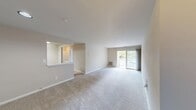 This Canterbury One Bedroom A1A apartment offers a well-designed 620 square foot living space. The heart of the home is an open-concept living and dining area, featuring plush carpeting and ample natural light from large windows. A sliding glass door leads to a private balcony, perfect for enjoying outdoor views.

The kitchen boasts a contemporary design with sleek gray cabinetry, providing contrast to white appliances including a refrigerator and electric range. Ample counter space and a practical layout make meal preparation efficient and enjoyable.

The spacious 170 square foot bedroom comfortably accommodates a large bed and additional furniture. It features a built-in closet for storage and a window that allows natural light to flood the space.

The bathroom is modern and functional, equipped with a vanity, mirror, and a shower/tub combination. The apartment's neutral color palette throughout creates a blank canvas for personal decorating styles.

This single-floor apartment combines comfort and convenience, making it an ideal home for individuals or couples looking for a cozy yet practical living space in the Canterbury community.