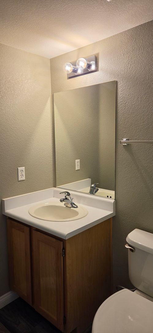 Building Photo - Two story 2 bedroom townhome with newer flooring, paint & appliances - community pool!