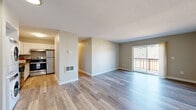 Located at 17135 SW Heritage Ct in Beaverton, Oregon, this single-floor residence offers a clean, modern aesthetic throughout. The open living area is anchored by light-toned wood-style flooring, neutral wall colors, and a textured ceiling, creating a bright and welcoming atmosphere. A sliding glass door floods the space with natural light and opens to a private balcony, extending the living area outdoors.

The kitchen is well-appointed with white cabinetry, dark countertops, and a full suite of stainless steel appliances, including a refrigerator, electric range, and dishwasher. The layout provides ample counter and storage space, making it highly functional. Conveniently positioned nearby is an in-unit stacked washer and dryer, adding everyday practicality.

The bedrooms feature plush carpeting and generous closet space, offering a comfortable and quiet retreat. The bathroom is finished with wood-style flooring, a white vanity with a clean-lined countertop, and a full tub-shower combination. Throughout the home, consistent neutral tones and updated finishes contribute to a cohesive, move-in-ready environment. The thoughtful layout and modern updates make this Beaverton residence a well-rounded and functional living space.