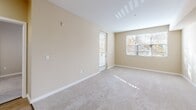 This well-appointed one-bedroom, one-bathroom residence is located at 888 N San Mateo Dr in San Mateo, California. The single-floor layout offers a thoughtfully designed open-concept living and kitchen area, finished with warm wood-look flooring that flows throughout the main spaces.

The kitchen serves as a centerpiece of the home, featuring a large island with a white quartz countertop, undermount sink, and pendant lighting overhead. Rich dark-wood cabinetry lines the walls, complemented by a full suite of stainless steel appliances, including a refrigerator, electric range, and built-in microwave.

The living room is bright and airy, with natural light streaming in through large windows that frame views of the surrounding neighborhood's mature trees. Plush carpeting adds warmth to this comfortable gathering space, which also provides access to a private balcony.

The bedroom offers a cozy retreat with soft carpet flooring, a generous window for natural light, and ample closet space — with three closets total throughout the residence. The bathroom is clean and modern, featuring a dark-wood vanity with a white countertop, a large mirror, and a tub/shower combination with sliding glass doors. An in-unit laundry area adds everyday convenience to this functional and stylish home.