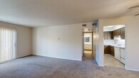 Located at 1846 Hamilton Rd in Okemos, Michigan, this single-floor, one-bedroom, one-bathroom unit offers a practical and comfortable layout across a compact but efficiently organized floor plan. The living room is the largest common area, featuring wall-to-wall carpeting, neutral-toned walls, and a sliding glass door dressed with vertical blinds that allows natural light to filter in and provides views of the surrounding greenery. An entry door with brass hardware opens directly into this welcoming space. The bedroom is generously sized, also finished with plush carpeting and light-colored walls. It is brightened by a window with a view of outdoor foliage, creating a calm, natural atmosphere. The kitchen is thoughtfully equipped with dark wood cabinetry — both upper and lower — offering ample storage. White laminate countertops, a stainless steel sink, a full-size refrigerator, and a dishwasher round out the functional cooking space, finished with tile flooring. The bathroom features a full tub and shower combination with white square tile surround, chrome fixtures, and matching tile flooring, maintaining a clean and classic aesthetic throughout. A hallway connects the rooms, contributing to an efficient and cohesive flow within the unit.