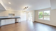 Located at 109 Mission St in Santa Cruz, California, this thoughtfully designed one-bedroom, one-bathroom residence offers a clean, modern aesthetic across a single floor. The open-concept kitchen and living area serves as the heart of the home, featuring warm wood-style flooring, crisp white walls, and an abundance of natural light streaming through large windows and sliding glass doors that open to a private balcony. The kitchen is well-appointed with white shaker cabinetry, dark granite-style countertops, and a full suite of stainless steel appliances including a refrigerator, electric range, microwave, and dishwasher. A stylish track lighting fixture illuminates the combined living space, while a wall-mounted mini-split unit provides efficient climate control. An entry closet offers convenient storage near the front door. The bedroom is a bright, serene retreat with a large window overlooking the surrounding neighborhood and a dedicated wall-mounted mini-split unit for personalized comfort. The bathroom is finished with wood-style flooring, a granite-topped vanity with an undermount sink, a large mirror, and a full tub-shower combination with tile surround. Throughout, the space maintains a cohesive, contemporary design with clean lines and neutral tones.