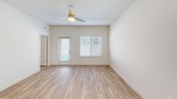 Located at 9000 Little Palm Way in Venice, FL, this single-story, one-bedroom, one-bathroom home offers a clean, modern design with an efficient and well-organized layout. Light-toned luxury vinyl plank flooring runs throughout, complementing the neutral wall palette and creating a bright, cohesive aesthetic.

The open-concept living and dining area is filled with natural light from multiple windows dressed with white blinds, and a ceiling fan adds comfort to the airy space. The kitchen is a standout feature, outfitted with crisp white shaker cabinetry, white quartz countertops, a subway tile backsplash in soft gray, and a full suite of stainless steel appliances including a French door refrigerator, electric range, microwave, and dishwasher. A central island provides additional prep and dining space, while pendant lighting adds a polished touch.

The spacious bedroom includes ample natural light, a ceiling fan, and access to two closets. The bathroom features a white vanity with brushed nickel hardware and a glass-enclosed walk-in shower. A dedicated laundry room with a full-size washer and dryer adds everyday convenience. The private patio with a grassy area rounds out this well-appointed home.
