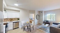 Located at 140 Holiday Blvd in Covington, Louisiana, this 1-bedroom, 2-bathroom unit offers a thoughtfully designed layout that maximizes every square foot. The living room features light hardwood-style flooring, neutral warm-toned walls, and a window with blinds that allows natural light to fill the space, creating a bright and welcoming atmosphere. The kitchen is outfitted with stainless steel appliances — including a full-size refrigerator, electric range, microwave, and dishwasher — complemented by white shaker-style cabinetry, a tile backsplash, and a dining area with space for a small table. The bedroom is a comfortable retreat with light flooring, natural light from a window with exterior views, and access to an adjoining area with built-in wire shelving for organized storage. Two full bathrooms each feature a tub-shower combination with a decorative curtain and tile flooring, providing practical functionality. Throughout the unit, the clean, neutral color palette and consistent flooring create a cohesive and calm aesthetic. The efficient floor plan ensures that each room is purposefully utilized, making this a practical and comfortable space in the heart of Covington.