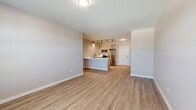 Located at 110 Cornell St in Kingston, NY, this single-floor residence offers three bedrooms and two bathrooms within a thoughtfully designed layout. The home features warm, light-toned luxury vinyl plank flooring that runs consistently throughout, complemented by neutral gray walls and clean white trim, creating a cohesive and modern aesthetic.

The open kitchen is a standout feature, showcasing a large peninsula with a bright white quartz countertop and an undermount sink with a matte black faucet. White shaker-style cabinetry lines the walls alongside a full suite of stainless steel appliances, including a refrigerator, range, and built-in microwave. Track lighting overhead adds both function and style to the space.

The bedrooms are well-proportioned and filled with natural light through double-hung windows with blinds. The primary bedroom offers generous space, while the secondary bedrooms include features such as sliding closet doors and louvered storage doors. The bathrooms are finished with gray shaker vanities topped with white countertops and matte black hardware accents. One bathroom includes a bathtub with a curved shower rod, while the second serves as a half bath. Clean white walls and consistent flooring tie both bathrooms seamlessly into the home's overall design.