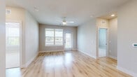 Located at 750 W Grand Pkwy S in Katy, Texas, this thoughtfully designed single-floor residence offers three bedrooms and five bathrooms with a clean, modern aesthetic. Light wood-look flooring flows throughout the main living areas, complemented by neutral warm-toned walls that create a bright, welcoming atmosphere. The open-concept kitchen and living area serves as the heart of the home, featuring crisp white shaker cabinetry with matte black hardware, a large center island with a white quartz countertop and undermount sink, a sleek subway tile backsplash, and stainless steel appliances including a French door refrigerator, range, microwave, and dishwasher. Pendant lighting above the island adds a refined finishing touch. The primary bedroom offers a generous footprint with its own en-suite access, while the additional bedrooms feature plush carpeting, ceiling fans, and large windows that invite an abundance of natural light and outdoor views. The five bathrooms are finished with marble-style tile surrounds, matte black fixtures, and wood-look flooring for a consistent, elevated look. A dedicated entrance, hallway, and closet round out the practical layout. The overall design balances modern style with functional living.