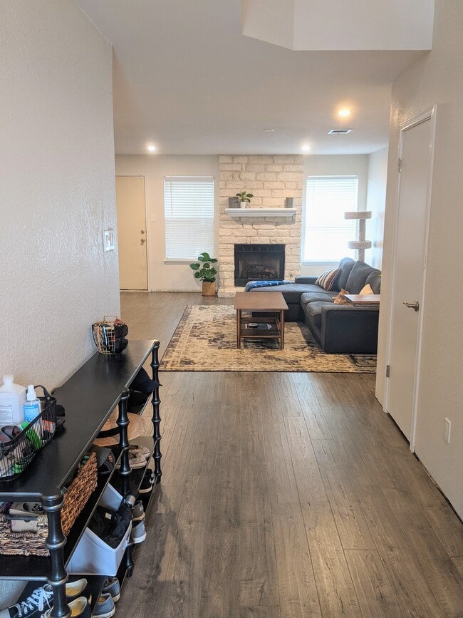 Entry with view of living room and powder room - 8645 Piney Creek Bend