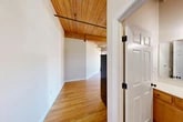 Located at 210 W Division St in Syracuse, NY, this 2-bedroom, 2-bathroom unit offers a distinctive loft-style aesthetic rooted in industrial heritage. Throughout the main living areas, warm hardwood floors pair with striking exposed wood beam ceilings and black pipe accents, creating an inviting yet characterful atmosphere. Large, multi-pane industrial-style windows allow abundant natural light to flood the space while framing views of the surrounding Syracuse neighborhood.

The kitchen is well-equipped with warm wood cabinetry, granite countertops, stainless steel appliances, and a peninsula that provides additional prep space. Tile flooring grounds this functional area, which transitions seamlessly to the rest of the unit.

The spacious primary bedroom benefits from oversized windows and continues the hardwood flooring found throughout. The second bedroom also features hardwood floors and natural light, making it equally versatile. Both bedrooms include dedicated closet space. The two bathrooms are finished with tile flooring; one includes a full tub-shower combination with grab bar accessibility features.

The overall layout is thoughtfully organized across a single floor, offering a cohesive open feel balanced with well-defined private spaces — ideal for those seeking character-rich living in an urban Syracuse setting.