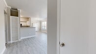Located at 6969 Hollister St in Houston, TX, this single-story, 2-bedroom, 2-bathroom home offers a well-organized layout with clean, contemporary finishes throughout. The open-concept living and kitchen area serves as the heart of the home, featuring light wood-look luxury vinyl flooring, crown molding, and a pendant-lit dining space that flows naturally into the living room. Large windows invite abundant natural light, creating a bright and airy atmosphere. The kitchen is equipped with white cabinetry, granite-look countertops, stainless steel appliances including a refrigerator and dishwasher, and a peninsula that doubles as a breakfast bar. The spacious primary bedroom features crown molding, a large walk-in closet with wire shelving, and access to a well-appointed en-suite bathroom with dual sinks, a granite-look vanity, and a full soaking tub. The second bedroom offers plush carpet, a ceiling fan, and its own closet with wire shelving. A second full bathroom features a single vanity, tub-shower combo, and matching light wood-look flooring. Three total closets provide ample storage throughout the home. The neutral color palette and consistent finishes give the entire space a cohesive, move-in-ready feel.