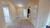 Located at 2825 Parkview Ln in Bedford, Texas, this single-story unit offers a practical and functional layout across several well-defined living spaces. The living room serves as the central gathering area, featuring a white-surround fireplace flanked by windows with blinds that allow natural light to filter in. A ceiling fan overhead and neutral-toned carpet underfoot contribute to a comfortable, understated atmosphere throughout the space.

The kitchen is equipped with dark espresso cabinetry, a black appliance suite including a range, microwave, and refrigerator, and a light speckled countertop that contrasts cleanly with the darker elements. Wood-look flooring runs through this area, providing a durable and easy-to-maintain surface.

The bedrooms are carpeted and generously proportioned, each with ceiling fans and access to closet storage. One bedroom features a sliding-door closet with a hanging rod, alongside a window offering an exterior view. Additional rooms provide open, adaptable spaces with textured ceilings throughout.

The bathroom includes a tub-shower combination, wood-look flooring, dark vanity cabinetry, a speckled countertop, and a lighted vanity mirror, delivering a clean and functional design. Overall, the unit presents a cohesive, neutral palette suited for comfortable everyday living.