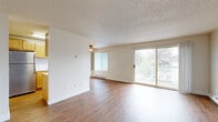Located at 19892 48th Ave W in Lynnwood, Washington, this 2-bedroom, 1-bathroom residence offers a well-organized single-level layout. The open living room is a welcoming focal point, featuring warm wood-style flooring, a textured ceiling, a ceiling fan, and a sliding glass door that opens onto a private balcony with outdoor views of surrounding greenery. Baseboard heating runs along the walls, ensuring year-round comfort, while multiple windows invite abundant natural light throughout.

The galley-style kitchen is efficiently designed with warm honey-toned cabinetry, white laminate countertops, wood-style flooring, and a suite of appliances including an electric range, dishwasher, and refrigerator. A window at the far end of the kitchen brings in additional natural light and views of the surrounding landscape.

Both bedrooms feature plush neutral carpeting and textured ceilings. The primary bedroom includes a closet with sliding doors, while the second bedroom is served by a standard closet and a window overlooking tree-lined surroundings. The full bathroom is clean and functional, equipped with a soaking tub and shower combination. Throughout the unit, neutral tones and practical finishes create a cohesive, move-in-ready environment.