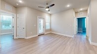 This single-story, 3-bedroom, 2-bathroom home offers a thoughtfully designed layout with modern finishes throughout. Light-toned luxury vinyl plank flooring runs continuously across the entire floor plan, complementing the neutral wall tones and crisp white trim work found in every room.

The kitchen is a standout feature, showcasing white shaker-style cabinetry, granite countertops, a subway tile backsplash, stainless steel appliances, and a peninsula island with a built-in sink — ideal for both cooking and casual dining. The adjacent living area benefits from natural light and a ceiling fan overhead.

The three bedrooms are comfortably sized, each featuring windows with blinds that allow for natural light and outdoor views. The primary bedroom offers generous proportions and convenient closet access. Two additional bedrooms provide flexibility for various living needs.

Both bathrooms are finished with white cabinetry, granite vanity countertops, and brushed nickel hardware. A dedicated laundry room accommodates a full-size washer and dryer with overhead cabinet storage for added convenience.

Three closets are distributed throughout the home, providing ample storage. The overall design is clean, cohesive, and move-in ready, making this a highly functional and attractive single-floor residence.
