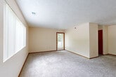 Located at 7319 Wirt Cir in Omaha, Nebraska, this single-floor, 3-bedroom, 1-bathroom home offers a practical and straightforward layout connected by a central hallway. The floor plan provides a comfortable sense of space distributed across its rooms.

The three bedrooms are carpeted throughout and finished with neutral, warm-toned walls and wood-trimmed baseboards and door frames. The generously sized primary bedroom is notably spacious, offering ample room for furnishings. The two additional bedrooms are well-proportioned and bright. Several bedrooms feature windows fitted with vertical blinds, allowing natural light to filter in and offering views of the surrounding greenery. One room includes direct access to an exterior door, providing added convenience.

The shared full bathroom is well-appointed, featuring a combination tub and shower, a toilet, and a wood-cabinet vanity with a single sink and mirror. The bathroom is finished with durable wood-look vinyl plank flooring, complementing the warm tones found throughout the home.

A central hallway connects the bedrooms and bathroom, providing an organized and efficient flow through the residence. The textured ceilings and consistent neutral palette give the home a clean, move-in ready appearance. Overall, this home offers a functional and comfortable layout suited for everyday living in a residential Omaha neighborhood.