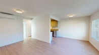 Located at 968 West 7th Street in Upland, CA, this single-story, one-bedroom, one-bathroom unit offers a thoughtfully designed layout with clean, modern finishes throughout. Light wood laminate flooring flows seamlessly across the entire unit, creating a bright and cohesive aesthetic.

The open-concept living, dining, and kitchen area forms the heart of the unit. The living room receives natural light through a large window fitted with horizontal blinds and features a flush-mount ceiling fixture. The galley-style kitchen is well-appointed with warm wood upper and lower cabinetry, light-toned countertops, a double sink with a modern faucet, a stainless steel range with overhead microwave, and a refrigerator — all opening toward the hallway and utility spaces.

The bedroom is a comfortable, well-lit room featuring a wall-mounted mini-split HVAC unit, a sliding glass door with vertical blinds leading to the private patio, and a closet with a hanging rod. The full bathroom is finished in crisp white with a combined tub and shower, a stone-top vanity with under-mount sink, and a small window for natural light.

Additional features include a dedicated hallway, a closet, a utility room, and an in-unit laundry area, offering practical everyday functionality throughout this well-maintained Upland residence.