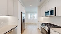 Located at 6535 Alvarado Road in San Diego, CA, this efficiently designed studio offers a clean, modern aesthetic with thoughtful use of space across its single floor. The open layout is unified by light-toned hardwood flooring and a bright, all-white color palette that enhances the sense of openness throughout.

The galley-style kitchen is a standout feature, lined with sleek, flat-front white cabinetry extending to the ceiling for maximum storage. It is equipped with stainless steel appliances, including a gas range, over-the-range microwave, refrigerator, and dishwasher. Subtle tile backsplash accents and recessed lighting complete the polished look. A window at the end of the kitchen draws in natural light and provides a view outward, brightening the entire space.

The bathroom is generously proportioned, featuring a wide vanity with white cabinetry and a neutral-toned countertop, a large mirror, and a combination tub and shower enclosed in a glass-panel surround. Natural light filters in through a window, adding to the airy feel of the room.

A dedicated walk-in closet offers built-in shelving and hanging rods, providing practical storage solutions. The entryway is clean and functional, seamlessly connecting all areas of the unit. Overall, the space delivers a cohesive, contemporary living environment with modern finishes and efficient design.