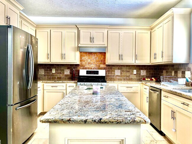 Huge island kitchen with shaker cabinets. - 10706 Allens Landing Dr
