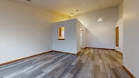 Located at 50 Coors Blvd in Pataskala, Ohio, this single-floor, 2-bedroom, 1-bathroom home offers a practical and comfortable layout. The open-concept living room and kitchen area serves as the heart of the home, featuring durable grey wood-look flooring, vaulted ceilings, and a ceiling fan with light fixture. A charming pass-through window connects the living area to the kitchen, adding architectural character and an open feel. Natural light flows in through windows fitted with blinds throughout the home.

The kitchen is well-appointed with white cabinetry accented by warm wood trim, ample counter space, a double-basin sink, a dishwasher, and a refrigerator, all complemented by wood-look flooring.

The generously sized primary bedroom features plush carpeting, a ceiling fan, and a window overlooking the exterior. The second bedroom is also carpeted and bright, with a window providing natural light. Both rooms are finished with warm wood baseboards for a cohesive look.

A hallway connects the bedrooms to the full bathroom, which includes a tub/shower combination with a decorative surround, a toilet, and wood-look flooring. The home's neutral palette and consistent finishes throughout create a clean, move-in ready atmosphere.