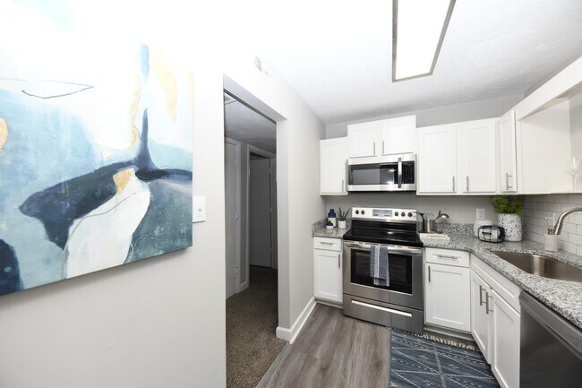 Kitchen with granite counters and stainless appliances - The Edwin