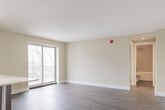 Located at 508 Mohawk Rd E in Hamilton, Ontario, this 2-bedroom, 1-bathroom unit offers a thoughtfully designed layout across a single floor. The open-concept kitchen and living area serves as the heart of the unit, showcasing a modern kitchen with rich dark-espresso cabinetry, a grey tile backsplash, stainless steel appliances, recessed lighting, and a granite-topped island with seating — ideal for both cooking and entertaining. The living area is bathed in natural light through a large sliding glass patio door that opens to an outdoor view, complemented by wood-look tile flooring that flows consistently throughout the unit. The primary bedroom features mirrored sliding closet doors, a bright window with exterior views, and a wall-mounted climate control unit. The second bedroom is a comfortable and versatile space with clean neutral finishes. The full bathroom is well-appointed with a dark wood-look tile floor, a rich vanity with granite countertop, a soaker tub, and a rainfall showerhead with subway tile surround. A connecting hallway ties all rooms together efficiently, completing this clean, contemporary, and move-in-ready unit.