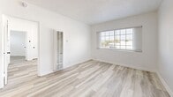 Located at 5940 San Fernando Rd in Glendale, CA, this 2-bedroom, 1-bathroom unit offers a thoughtfully updated interior within a compact, single-floor layout. Light wood-style flooring runs consistently throughout all rooms, creating a cohesive and clean aesthetic that enhances the sense of openness.

The kitchen features a galley-style configuration with white shaker cabinetry, brushed gold hardware, a quartz countertop, a stainless steel undermount sink, and a striking black-and-white patterned tile backsplash that serves as a focal point. Stainless steel appliances complete the functional setup.

The primary bedroom is a comfortable, well-proportioned room with a ceiling fan and direct access to adjacent spaces. The second bedroom includes a wall-mounted AC unit, a window providing natural light, and clean white walls. A bright living area features multiple windows with exterior views, a ceiling fan, and a textured ceiling, allowing ample natural light throughout.

The bathroom is finished with white shaker vanity cabinetry, a quartz countertop, a framed mirror, and a full bathtub with an overhead rain showerhead, all finished in a clean, contemporary style consistent with the rest of the unit.