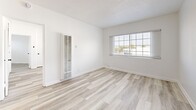 Located at 5940 San Fernando Rd in Glendale, CA, this 2-bedroom, 1-bathroom unit offers a thoughtfully updated interior within a compact, single-floor layout. Light wood-style flooring runs consistently throughout all rooms, creating a cohesive and clean aesthetic that enhances the sense of openness.

The kitchen features a galley-style configuration with white shaker cabinetry, brushed gold hardware, a quartz countertop, a stainless steel undermount sink, and a striking black-and-white patterned tile backsplash that serves as a focal point. Stainless steel appliances complete the functional setup.

The primary bedroom is a comfortable, well-proportioned room with a ceiling fan and direct access to adjacent spaces. The second bedroom includes a wall-mounted AC unit, a window providing natural light, and clean white walls. A bright living area features multiple windows with exterior views, a ceiling fan, and a textured ceiling, allowing ample natural light throughout.

The bathroom is finished with white shaker vanity cabinetry, a quartz countertop, a framed mirror, and a full bathtub with an overhead rain showerhead, all finished in a clean, contemporary style consistent with the rest of the unit.