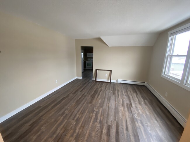 Spacious living room with new wood floors! - 153 4th Ave S