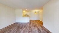 Located at 9052 Westlake Dr in Greendale, Wisconsin, this single-floor residence offers a well-planned layout with a clean, contemporary aesthetic throughout. The open-concept living and dining area is finished with warm wood-tone luxury vinyl plank flooring and bright white walls, creating an airy, welcoming atmosphere. A stylish pendant light fixture anchors the dining area, while recessed lighting adds warmth near the kitchen.

The kitchen features a peninsula with bar-height seating, white cabinetry, stone-look countertops, and Whirlpool appliances including a range and over-the-range microwave. A closet just off the kitchen provides convenient storage.

The bedrooms are carpeted and generously sized, each offering large windows that frame views of the lush, tree-lined outdoor surroundings and fill the rooms with natural light. One bedroom includes a sliding glass door that opens directly to an outdoor patio area with scenic greenery.

Two full bathrooms serve the residence. One features white cabinetry, a single vanity, tile flooring, and a glass-enclosed shower. The second bathroom mirrors the clean, bright design with a full tub-shower combination, tile flooring, and white vanity. Together, the spaces offer a functional and comfortable living environment in a serene Greendale setting.