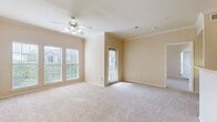 This 600 square foot apartment in Cedar Park, Texas, offers a well-designed living space that maximizes functionality. The single-floor layout includes one bedroom, measuring 150 square feet, and one bathroom. The heart of the home is an open-concept kitchen and living room area, creating a spacious feel despite the compact footprint.

Large windows throughout flood the space with natural light, enhancing the sense of openness. The living area features plush carpeting and a ceiling fan for comfort. The kitchen boasts wooden cabinets, a full-sized refrigerator, and a built-in microwave, with a partial wall separating it from the living space while maintaining an open feel.

The bedroom continues the bright, airy theme with a large window and neutral color scheme. The bathroom combines practicality with style, featuring a shower/tub combo, wooden cabinetry, and durable wood-look flooring.

Additional amenities include in-unit laundry facilities and ample closet space. The apartment's neutral color palette provides a blank canvas for personalization. Located at 1600 S Lakeline Blvd in Cedar Park, this apartment offers a comfortable and efficient living solution in a desirable area.
