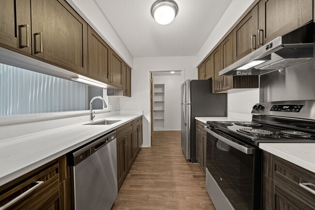 Modern kitchen with stainless steel appliances at Franklin River Apartments in Southfield, MI - Franklin River Apartments
