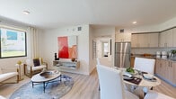Located at 5961 SW 68th St in South Miami, FL, this well-appointed 3-bedroom, 2-bathroom residence offers a thoughtfully designed single-floor layout with a clean, contemporary aesthetic throughout. Light wood-style flooring flows seamlessly across the open-concept living, dining, and kitchen area, creating a bright and cohesive atmosphere. The kitchen is equipped with stainless steel appliances including a refrigerator, range, microwave, and dishwasher, complemented by two-tone cabinetry in light wood and white, granite countertops, and a practical layout ideal for everyday use. The adjacent dining area provides an intimate space that connects naturally to the living room, which features a built-in floating shelf and large windows offering outdoor views of lush green surroundings. Each bedroom is finished with light flooring, ceiling fans, and ample closet space. The primary bedroom is a well-proportioned retreat with a dedicated closet. A secondary bedroom offers outdoor views and versatile flex space. The two bathrooms are finished with tile flooring, granite-topped vanities with light wood cabinetry, large mirrors, and walk-in showers with full tile surrounds and accessibility grab bars, reflecting a modern and functional design sensibility throughout.