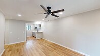 Located at 2500 S I-10 Service Rd E in Metairie, Louisiana, this thoughtfully updated one-bedroom, one-bathroom unit offers a clean, modern aesthetic across a single floor. Light wood-tone flooring flows seamlessly throughout every room, creating a cohesive and bright atmosphere complemented by neutral gray walls and recessed lighting.

The open living room is a comfortable, well-proportioned space featuring crown molding, a ceiling fan, and a sliding glass door that invites natural light and provides outdoor access. The layout connects naturally to a dedicated hallway leading to the remaining rooms.

The kitchen is a standout feature, outfitted with gray shaker-style cabinetry, crisp white quartz countertops, a matte black faucet, and stainless steel appliances including a refrigerator, range, and dishwasher. A window above the sink allows for natural light to brighten the workspace.

The bedroom is a well-sized retreat with a ceiling fan, a window with blinds, and the same warm wood flooring found throughout the unit. A convenient in-unit stacked washer and dryer is accessible nearby, adding practical functionality to the layout.

The bathroom is finished with a white vanity, undermount sink, matte black fixtures, a mirrored medicine cabinet, and a window that provides ventilation and natural light. The overall design is clean, modern, and move-in ready.