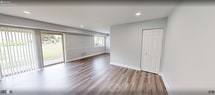 This well-designed 670 square foot apartment offers a harmonious blend of comfort and style. The single-floor layout comprises one bedroom, one bathroom, and an open-concept living area. The living room is bright and airy, with recessed lighting and a large sliding glass door that leads to a private outdoor patio, allowing natural light to flood the space.

The kitchen boasts modern amenities, including stainless steel appliances, dark wood cabinetry, and granite countertops. Its galley-style layout maximizes efficiency while maintaining an open feel to the living area.

The bedroom, measuring 190 square feet, features plush carpeting and a spacious closet, providing ample storage. The bathroom is outfitted with a tub-shower combination, a stylish vanity with granite countertop, and is accessorized with a nautical-themed shower curtain.

Throughout the apartment, you'll find a cohesive design with light grey walls, white trim, and durable wood-look flooring in the main living areas. The combination of these elements creates a contemporary and inviting atmosphere, perfect for modern living.