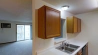 This single-floor space offers a practical and comfortable layout designed for everyday living. The kitchen is equipped with warm-toned wood cabinetry that provides generous storage, complemented by a double stainless steel sink set into a light-colored countertop. A textured ceiling adds a classic touch overhead, while flush-mount lighting ensures the area remains well-lit. The kitchen opens directly into the living area, creating a seamless, open-concept flow between the two spaces. The living area features plush carpeting underfoot and is anchored by a large sliding glass door that stretches toward the ceiling, inviting an abundance of natural light and offering views to the outdoors. The overall ambiance of the space is functional and inviting, with a neutral color palette throughout that lends itself well to a variety of interior styles. The open sightlines between the kitchen and living area make the space feel connected and easy to navigate, while the natural light from the sliding glass door enhances the sense of openness across the entire floor plan.