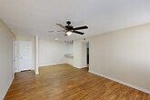 Located at 4445 Alvin Dark Ave in Baton Rouge, Louisiana, this single-story, 3-bedroom, 4-bathroom home offers a well-organized and functional layout. The combined living and dining area serves as the heart of the home, featuring warm hardwood-style flooring, neutral wall tones, and ceiling fans throughout. Natural light filters in through multiple windows, while French doors open directly onto a patio, extending the living space outdoors.

The kitchen stands out with bold navy blue shaker-style cabinetry, granite countertops, black appliances including a refrigerator and dishwasher, a range hood, and a breakfast bar peninsula — ideal for both cooking and casual dining.

Each of the three bedrooms continues the hardwood-style flooring and ceiling fan theme, providing a consistent and comfortable feel. Several bedrooms include closets, with the home boasting a total of six closets for ample storage. The four bathrooms are clean and functional, each featuring tub-shower combinations and wood-toned vanities with blue cabinetry accents that mirror the kitchen's design.

Additional highlights include a dedicated laundry area and a hallway connecting the bedroom wing. The overall aesthetic is clean, modern, and move-in ready, making this home a practical and attractive option in Baton Rouge.
