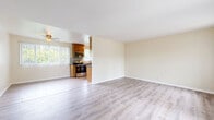 Located in Culver City, CA, this single-floor 2-bedroom, 2-bathroom residence offers a comfortable and well-designed layout across a generous footprint. The open living room is bright and airy, featuring light wood-style flooring and large windows dressed with vertical blinds that invite abundant natural light and outdoor views. The kitchen is thoughtfully equipped with warm wood cabinetry, dark granite-style countertops, a mosaic tile backsplash, and a full suite of stainless steel appliances including a range, microwave, dishwasher, and refrigerator. Large tile flooring and a ceiling fan add to the kitchen's functional appeal. Both bedrooms are well-proportioned, each featuring light wood flooring, ceiling fans, and windows overlooking lush greenery. The primary bedroom includes a mirrored sliding-door closet, adding a sense of depth and storage convenience. A second closet is also available within the unit. The bathrooms are clean and efficiently designed, with one featuring a glass-enclosed standing shower with white tile surround. A hallway connects the rooms, contributing to a logical and flowing floor plan. The warm, neutral color palette throughout creates a cohesive and inviting atmosphere ideal for comfortable everyday living.