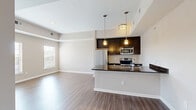 Located at 1206 Robert Rose Dr in Murfreesboro, TN, this thoughtfully designed one-bedroom, one-bathroom residence offers a efficient and functional single-floor layout. The open-concept living area seamlessly connects the living room, dining space, and kitchen, creating an inviting and versatile environment. Warm-toned hardwood-style flooring runs throughout the main living areas, complemented by neutral walls and tray ceiling details that add architectural interest.

The kitchen is a standout feature, showcasing rich dark espresso cabinetry, gleaming granite countertops, a large peninsula with an undermount sink, and a full suite of stainless steel appliances including a refrigerator, electric range, and built-in microwave. Stylish pendant lighting above the peninsula adds a modern touch.

The bedroom is a comfortable retreat featuring a tray ceiling, dual windows with blinds that allow for abundant natural light, and views of the surrounding area. Three closets, including a spacious walk-in with built-in wire shelving and plush carpet flooring, provide generous storage.

The bathroom features large-format tile flooring, a white vanity with ample cabinet storage, light countertops, and a well-lit mirror. Additional conveniences include a dedicated laundry area and a welcoming entrance foyer.