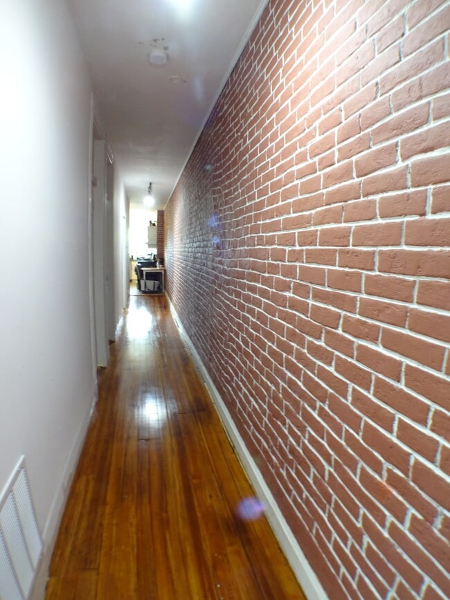 Long real brick but sealed so no dust hallway as you enter the apartment, the three bedrooms on on the left, each with a small closet and big enough for a queen bed, kitchen and baths at the end of this hallway... - 2 Bay Street