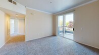 Located at 3401 Savannah Ln in West Sacramento, CA, this 2-bedroom, 2-bathroom residence offers a thoughtfully organized single-story layout. The entryway opens through a hallway with warm hardwood-style flooring that transitions into the main living areas. The living room is bright and inviting, featuring plush carpeting, crown molding, and a sliding glass door that leads to a private balcony with outdoor views. Adjacent to the living area, the kitchen is outfitted with rich wood cabinetry, light countertops, hardwood-style flooring, and white appliances including a full-size refrigerator and electric range. Both bedrooms are carpeted and filled with natural light from multiple windows dressed with vertical blinds. Ceiling fans are featured in each bedroom, enhancing comfort. The primary bedroom offers generous proportions with ample closet access. The two bathrooms are finished with wood-toned vanity cabinetry, light countertops, and hardwood-style flooring. One bathroom includes a shower-tub combo, while the other features a standalone shower enclosure. Throughout the residence, neutral tones and consistent finishes create a clean, cohesive aesthetic that is both practical and welcoming.