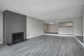 Located at 11858 Goshen Ave in the desirable Brentwood neighborhood of Los Angeles, this thoughtfully renovated single-floor unit offers a clean, modern aesthetic throughout. Light wood-style flooring runs continuously across the living spaces, complemented by neutral warm-beige walls and crisp white baseboards that create a bright, cohesive interior.

The kitchen is a standout feature, designed in a generous galley layout with an abundance of gray shaker-style cabinetry, brushed nickel hardware, and white quartz countertops. Stainless steel appliances — including a refrigerator, range, microwave, and dishwasher — provide a polished, contemporary finish. A breakfast bar peninsula connects the kitchen to the open living and dining area, enhancing the flow of the space.

The living area is spacious and filled with natural light from a large sliding glass door that opens to a private balcony. Built-in shelving and closet space add functional storage to the living zone. The textured ceilings provide a subtle architectural contrast to the otherwise clean lines of the unit.

The bathrooms are finished with speckled quartz-style countertops, undermount sinks, framed mirrors, and white cabinetry — offering a tidy, well-appointed design. Throughout, the unit presents a move-in-ready condition with updated finishes that reflect a modern sensibility suited to the Westside Los Angeles lifestyle.