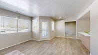Located at 1580 W 3940 S in West Valley City, Utah, this well-designed 2-bedroom, 2-bathroom single-story home offers a comfortable and functional layout. The living room greets you with an abundance of natural light streaming through multiple large windows with blinds, complemented by durable wood-look plank flooring and a private exterior door that adds convenience and accessibility. The kitchen is efficiently arranged with light wood cabinetry, white countertops, stainless steel appliances including a full-size refrigerator and electric range, and matching wood-look flooring that ties the space together. Both bedrooms are carpeted and finished in neutral tones, providing a calm and restful atmosphere. The generously sized primary bedroom features direct access to a walk-in closet with built-in wire shelving and an en-suite bathroom. The second bedroom is well-proportioned and ideal for guests or a home office. The two bathrooms are finished with wood-look flooring and clean, simple fixtures, including a shower-tub combination. A dedicated utility room and an additional closet provide practical storage solutions throughout. The home's consistent neutral palette and clean finishes create a cohesive, move-in-ready feel.