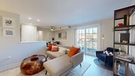 This single-floor residence offers a thoughtfully designed layout that blends comfort and modern style throughout. The open-concept living area is bright and welcoming, anchored by large sliding glass doors that invite natural light and provide access to an outdoor balcony with exterior views. Light hardwood-style flooring runs seamlessly throughout the main living spaces, complementing the neutral wall tones that give the home a clean, airy feel. A ceiling fan overhead adds both function and a casual design touch to the living space.

Adjacent to the living area, the dedicated dining space accommodates a round table and seating for four, accented by framed wall art and a ceiling fan. The kitchen features contemporary wood-grain cabinetry, white countertops, and a full suite of white appliances including a range, over-the-range microwave, dishwasher, and refrigerator — all finished with light flooring for a cohesive look.

The bedroom is generously sized with a double closet, a window with natural light, and neutral tones that create a calm retreat. The bathroom is finished with large-format tile flooring and wall surround, a sliding glass tub-shower enclosure, and a sleek white vanity with modern hardware. A closet with built-in storage rounds out the practical features of this well-balanced residence.