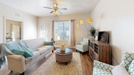 This single-floor residence offers a thoughtfully designed layout that balances comfort and functionality. The open-concept living area features warm hardwood-style flooring, a ceiling fan, and windows that invite natural light, creating a bright and welcoming atmosphere. A peninsula kitchen anchors the space with dark espresso cabinetry, granite-look countertops, black appliances including a refrigerator, range, and built-in microwave, and a breakfast bar with bar seating — ideal for casual dining or entertaining.

Both bedrooms are carpeted and well-proportioned, each accommodating a full-size bed with room to spare. Natural light filters in through windows dressed with blinds and curtains, lending a calm, restful ambiance to each room. One bedroom serves as a versatile secondary space, currently styled as a sitting or hobby room with ample shelving and natural light.

The two full bathrooms mirror each other in finish, each featuring tile flooring, a tub-shower combination, dark vanity cabinetry with granite-style countertops, and clean, neutral tones. A dedicated nook with tile flooring provides a convenient spot for a pet area. The cohesive design palette of warm neutrals and dark wood accents carries throughout, giving the entire residence a polished and unified feel.