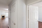 This single-story, one-bedroom, one-bathroom home in Houston, TX offers a well-organized layout designed for comfortable everyday living. Rich hardwood-style flooring flows throughout the entire space, creating a cohesive and warm aesthetic from room to room.

The living room serves as the heart of the home, highlighted by a tile-surround fireplace with a clean white mantel and a ceiling fan overhead. Natural light enters through blinds-fitted windows, and a glass-panel door opens to the exterior, enhancing the sense of openness. An adjacent dining area connects seamlessly to the living space, ideal for casual entertaining.

The kitchen is equipped with stainless steel appliances, white cabinetry, and granite countertops that extend to a breakfast bar — a practical and stylish feature for dining or food prep. A dedicated laundry area with a stacked washer and dryer unit is conveniently positioned nearby, alongside a pantry for additional storage.

The bedroom is generously sized, fitted with a ceiling fan, natural light from multiple windows, and access to multiple closets, including a spacious walk-in with wrap-around shelving and hanging rods. The bathroom features a full tub-shower combination with floor-to-ceiling tile surround. A dedicated utility room and entrance area round out this thoughtfully arranged home.