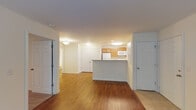 Located at 2202 Juliet Pl in Greensboro, North Carolina, this single-floor residence offers a functional and well-appointed layout designed for comfortable everyday living. The open-concept living and dining area is finished with rich, warm-toned hardwood-style flooring that flows throughout the main living spaces, creating a cohesive and inviting atmosphere. The entry transitions seamlessly into the main living area, which is bright and neutrally painted to maximize the sense of openness.

The kitchen is designed in a galley style, featuring honey-toned wood cabinetry, light countertops, a double stainless steel sink, and white appliances including a range, microwave, and dishwasher. A peninsula counter connects the kitchen to the living area, providing additional workspace and a casual dining option.

The bedrooms are carpeted for comfort and include windows dressed with blinds that allow natural light to filter in. One bedroom features a ceiling fan with an integrated light fixture. The bathroom is finished with matching wood cabinetry, a vanity with ample counter space, and durable hardwood-style flooring. Overhead cabinetry provides additional storage. Throughout the residence, clean white walls and consistent trim work contribute to a tidy, move-in-ready presentation.