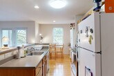 Located at 402 14th St NW, Unit 3B in Charlottesville, VA, this well-appointed residence offers three bedrooms, three bathrooms, and a thoughtfully designed single-floor layout. The open-concept kitchen features warm wood cabinetry, stainless steel appliances, and a peninsula with bar seating — ideal for casual dining or entertaining. Adjacent to the kitchen, the living room is bright and welcoming, with hardwood flooring, neutral walls, and glass doors that open onto a private balcony overlooking a lush, tree-lined setting. A dedicated dining area with a window view adds a functional and inviting space for meals. The spacious primary bedroom is filled with natural light from dual windows and features plush carpeting, providing a comfortable retreat. Additional bedrooms are well-sized with carpeted floors and direct bathroom access. All three bathrooms are practical and clean, featuring warm wood cabinetry, tiled flooring, and tub-shower combinations. A utility room rounds out the floor plan. Throughout the residence, a consistent palette of neutral tones, hardwood floors in common areas, and ample natural light create a cohesive and comfortable living environment.