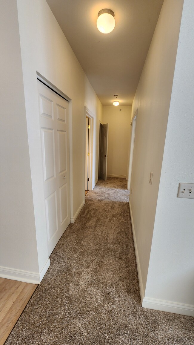 Hall to Beds and first full bathroom - Uptown Brass Apartments