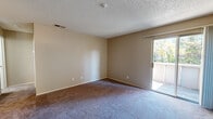 This one-bedroom, one-bathroom residence in Rohnert Park, California offers a practical and well-organized single-floor layout. The galley-style kitchen is a functional highlight, featuring white shaker cabinetry, white quartz-style countertops, stainless steel appliances including an electric range, dishwasher, and refrigerator, a stainless steel sink, and wood-look flooring that adds warmth to the space. A ceiling fan is also present near the kitchen area.

The living area is carpeted and bathed in natural light, with a sliding glass door that opens to a private balcony offering pleasant outdoor views of surrounding trees. The textured ceiling and neutral warm-toned walls create a consistent, understated aesthetic throughout.

The bedroom is a comfortable, carpeted room with a window framing tree views, a textured ceiling, and access to closet space. Two closets serve the unit, providing ample storage. The bathroom includes a full tub-shower combination with white tile surround, a grab bar, and wood-look flooring, maintaining a clean and functional design.

Overall, this residence presents a straightforward and livable layout suited for individuals or couples seeking a manageable, well-appointed space in Rohnert Park.