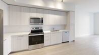 This 640 square foot apartment in Boca Raton, FL offers a thoughtfully designed living space on a single floor. The modern kitchen is a standout feature, boasting sleek white cabinetry, stainless steel appliances, and a functional layout. It includes a side-by-side refrigerator, built-in microwave, and electric range, all complemented by ample counter space and a single-basin sink.

The 140 square foot bedroom is generously sized, featuring a large window that allows natural light to flood the space. The room is equipped with a ceiling fan and offers enough space for a queen-sized bed and additional furniture. A spacious closet with wire shelving provides abundant storage options.

The bathroom is well-appointed with a modern vanity, large mirror, and a combined shower-tub unit. Light-colored tile extends from the floor to the shower walls, creating a cohesive and bright appearance.

Throughout the apartment, light wood-look flooring adds warmth and continuity. The neutral color palette, predominantly whites and light grays, creates a clean and contemporary aesthetic. The open concept living area seamlessly connects to the kitchen, maximizing the use of space in this efficient floor plan.

A hallway provides access to all rooms and includes additional storage solutions. The apartment's layout is designed to optimize every square foot, making it an ideal choice for those seeking a modern, low-maintenance living space in a desirable Boca Raton location.